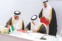  ?? WAM ?? Obaid Humaid Al Tayer and Shaikh Ahmad Bin Mohammad Al Khalifa sign the financial cooperatio­n agreement as Dr Abdul Rahman Bin Abdullah Al Humaidi looks on.