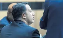  ?? LANNIS WATERS/THE PALM BEACH POST ?? Nouman Raja, who is charged with shooting and killing Corey Jones, talks to his attorney Friday afternoon in West Palm Beach.
