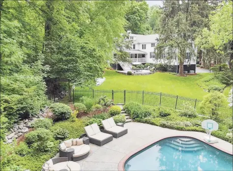  ?? Contribute­d photo ?? 53 Hillcrest Park Road is situated on a 1.10-acre lot, with mature trees and perennial plantings.