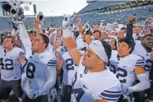  ?? AP PHOTO/AL GOLDIS ?? BYU football players celebrate after a 31-14 road win at Michigan State on Oct. 8, 2016.