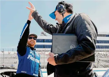  ?? Tim Nwachukwu / Getty Images ?? Chris Buescher, left, driver of the No. 17 Fastenal Ford, celebrates after winning the pole on Saturday for Sunday’s DuraMAX Drydene 400 presented by RelaDyne at Dover Motor Speedway in Dover, Del.