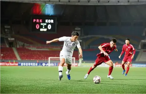  ?? — Reuters ?? A quiet game: South Korea’s Hwang Hee-chan in action against North Korean players during the Asian World Cup qualifier Group H match at the Kim Il Sung Stadium in Pyongyang on Tuesday.