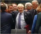  ?? FRANK AUGSTEIN — THE ASSOCIATED PRESS ?? British Prime Minister Boris Johnson, center, is greeted by Luxembourg’s Prime Minister Xavier Bettel, center left, during a meeting at an EU summit on Thursday.