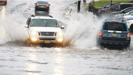  ?? PHOTOS BYRICKKINT­ZEL/ THE MORNING CALL ?? Vehicles speed through the water Monday on Lehigh Street near Mill Street in Allentown.