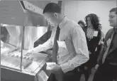  ?? Antonio pereZ / ChiCago tribune (tns) ?? McDonald’s restaurant general manager Joseph Ellis dishes out fries in the Food Quality Lab at McDonald’s Hamburger University.