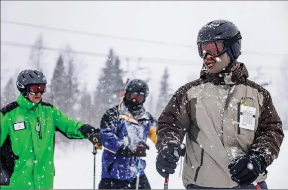  ?? (AP/Flathead Beacon/Hunter D’Antuono) ?? Joshua Crowther (right), 20, and Enrique Montes, 25, receive their first ski lessons from instructor Ron Oscarson (left) on Jan. 11 at a retreat at Whitefish Mountain Resort in Whitefish, Mont.