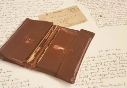  ??  ?? This wallet was carried by a Jewish soldier in World War I. It slowed a bullet and saved the life of its owner.