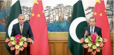  ?? Associated Press ?? ↑ Wang Yi (right) and Shah Mahmood Qureshi address a joint press conference in Beijing on Tuesday.