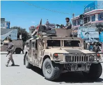  ?? AFP/GETTY IMAGES ?? Afghan security forces stand guard in Kunduz on Tuesday.