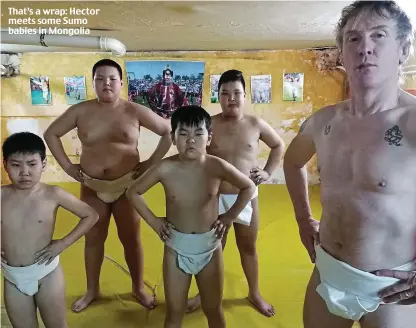  ??  ?? That’s a wrap: Hector meets some Sumo babies in Mongolia