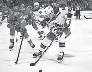  ?? TIM FULLER/USA TODAY SPORTS ?? Rangers left wing Artemi Panarin brings the puck up the ice against Red Wings defenseman Moritz Seider during the first period on Friday.