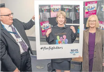  ??  ?? Health Secretary Shona Robison joins NHS Fife chief executive Paul Hawkins and chairwoman of NHS Fife Tricia Marwick in their Flu Fighters campaign at Victoria Hospital in Kirkcaldy.