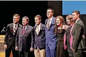  ?? [PHOTO BY JIM BECKEL, THE OKLAHOMAN] ?? Oklahoma gubernator­ial candidates pose for a group photo after the debate at Oklahoma City Community College on Thursday night. From left are Jayke Flaggart of Choctaw High School, Democrat Drew Edmondson, Cade Jenlink of Timberlake High School, Republican Kevin Stitt, Emily Kennedy of Edmond North High School, Courtney Tillinghas­t of Owasso High School and Peyton Burns of Kingfisher High School.