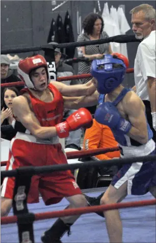  ??  ?? Above: Swift Current's Jaden Toye (at left) and Weyburn's Elias Weston duke it out during their 54-kg bout. Right: Swift Current's Dashanda Fehr-Spence (at left) loses her balance while trying to avoid a blow by Lloyminste­r's Sydney Collinge.