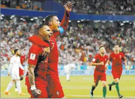  ?? Pavel Golovkin ?? The Associated Press Portugal’s Ricardo Quaresma, left, celebrates with Cristiano Ronaldo after scoring during a 1-1 draw against Iran on Monday in Saransk, Russia.