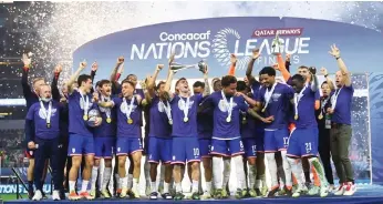  ?? — AFP photo ?? The USA players celebrate capturing a third consecutiv­e CONCACAF Nations League title by defeating Mexico 2-0 in the final.