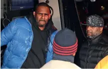  ??  ?? R. Kelly arrives at the 1st District-central police station on February 22 in Chicago, Illinois