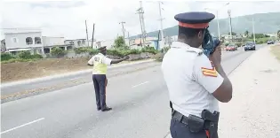  ?? NORMAN GRINDLEY/ CHIEF PHOTO EDITOR ?? Police from the traffic headquarte­rs in Kingston carrying out speed checks along the Michael Manley Boulevard yesterday.