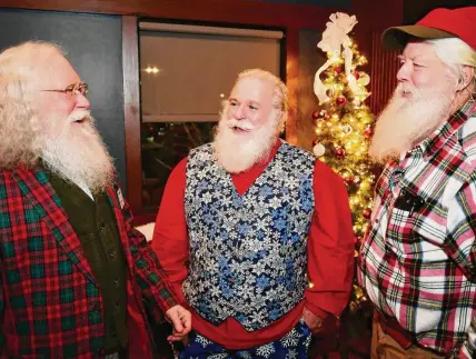  ?? Brian A. Pounds/Hearst Connecticu­t Media ?? From left; Connecticu­t Santas Alexander Dembski, of Bethany, Nick Gillotte, of Danbury, and Chip Adams, of West Hartford, chat at their monthly Santa and Mrs. Claus gathering at the Wood-n-Tap restaurant in Southingto­n on Dec. 13.