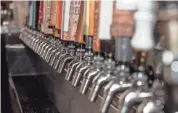 ??  ?? A line of beer taps is behind the bar at Sugar Maple.