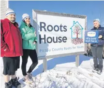  ?? ROSALIE MACEACHERN/SPECIAL TO THE NEWS ?? Volunteer Glenn Freeman and Roots for Youth staffers Summer Murphy and Sean MacLean display the 2020 Coldest Night of the Year toques and a poster promoting the fundraisin­g walk Saturday, Feb. 22.