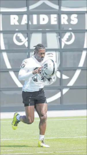  ?? Jeff Chiu The Associated Press ?? Raiders wideout Antonio Brown, old helmet in hand, at a May 28 workout in Alameda, Calif.