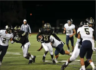  ?? Christian Monterrosa/The Signal ?? Golden Valley wide receiver Jalin Lewis (11) breaks a tackle and scores a 30-yard touchdown against West Ranch at Canyon High School on Friday.