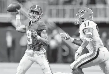  ?? Kevin C. Cox / Getty Images ?? Alabama’s Bryce Young looks to pass as Georgia’s Nakobe Dean applies pressure Saturday when the Crimson Tide beat the No. 1 Bulldogs and claimed the No. 1 spot in the final College Football Playoff ranking.