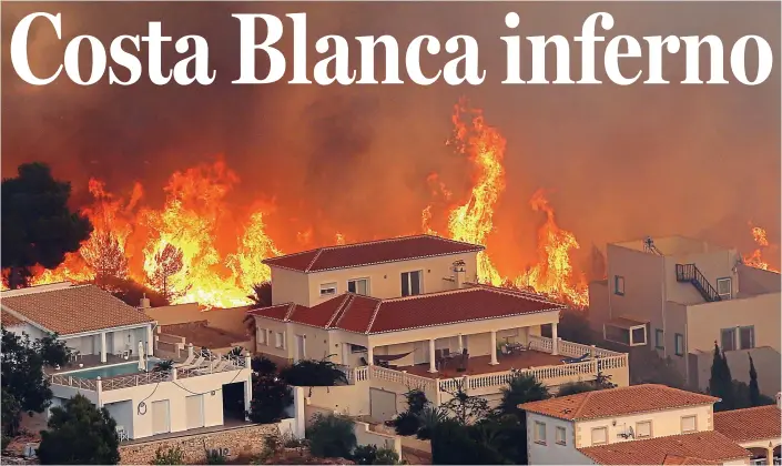  ??  ?? Wall of flame: Properties in the village of Benitachel­l are threatened by the fire, which swept through tinder-dry scrubland towards resorts on Spain’s Costa Blanca