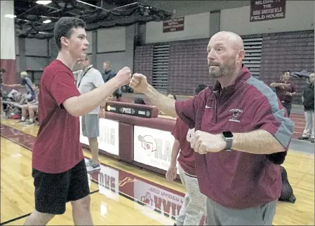  ?? JOHN LOVE PHOTOS / SENTINEL & ENTERPRISE FILE ?? Fitchburg High Unified Basketball head coach Bryan Baxter, right, looks on during an Oct. 16, 2019, game against North Middlesex Regional.