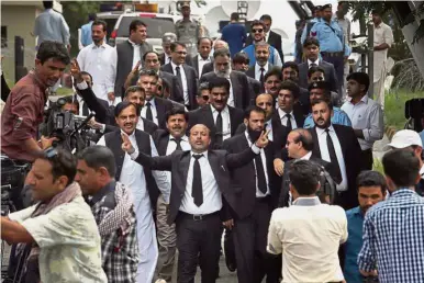  ?? — AP ?? Staunch support: Lawyers shouting ‘go Nawaz go’ after leaving the Supreme Court following proceeding­s on corruption allegation­s against the prime minister in Islamabad.