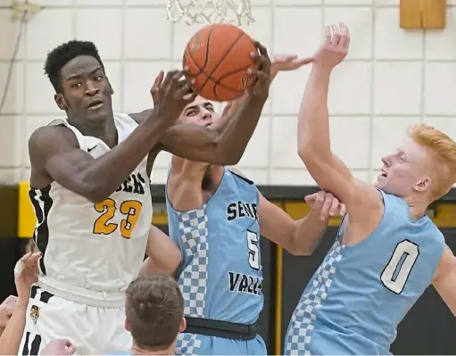  ?? Peter Diana/Post-Gazette ?? North Allegheny’s Khalil Dinkins pulls a rebound away from Seneca Valley’s Luke Lawson. Dinkins finished with 14 points.