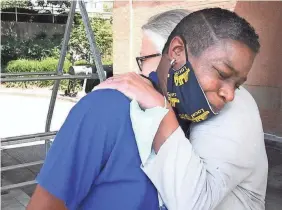  ?? LARRY MCCORMACK/USA TODAY NETWORK ?? Assistant manager Jackie Vandal, of the Kroger store in Nashville, Tenn., hugs LaShenda Williams, who was living in her car in the store’s parking lot. Williams now has her own apartment and has worked at the store for eight months.