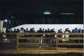  ?? ELI HARTMAN — ODESSA AMERICAN ?? Migrant children and teenagers are processed after entering the site of a temporary holding facility south of Midland, Texas.