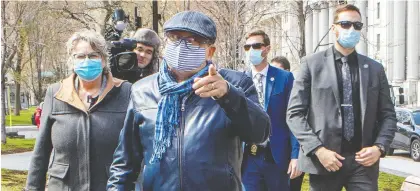  ?? JOHN MAHONEY ?? Quebec director of public health Dr. Horacio Arruda, centre, admonishes a photograph­er for not wearing a mask during a visit to a day centre for the homeless in Place du Canada on Friday. Also on Friday, the province unveiled a “mass screening” plan for the Montreal region.