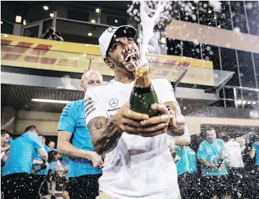  ?? — GETTY IMAGES ?? Race winner Lewis Hamilton of Great Britain and Mercedes celebrates with his team after the Abu Dhabi Formula One Grand Prix at Yas Marina Circuit on Sunday in the United Arab Emirates.