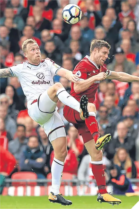  ??  ?? Burnley’s goalscorer, Scott Arfield, challenges Liverpool’s James Milner for possession