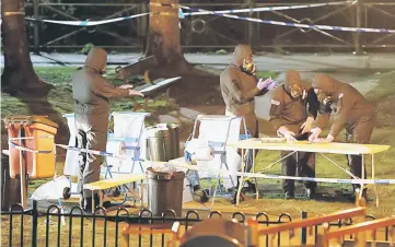  ??  ?? Members of the emergency services wearing protective clothing work next to a children’s play area near the bench where former Russian intelligen­ce officer Sergei Skripal and his daughter Yulia were found poisoned in Salisbury, Britain.