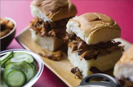  ?? NYT ?? Shredded pork sliders with gochujang barbecue sauce, made using an electric pressure cooker.