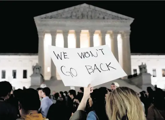  ?? ALEX BRANDON AP ?? People gather outside the Supreme Court in Washington on Monday night after a news report was published about a draft of the court’s abortion ruling.