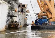  ?? ST. SIMONS SOUND INCIDENT RESPONSE ?? As workers continue to cut apart the shipwrecke­d Golden Ray and remove its parts, cleanup crews continuall­y monitor and work to contain oil that leaks into the water from the operation.