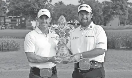  ?? JONATHAN BACHMAN/GETTY IMAGES ?? Rory McIlroy, left, and Shane Lowry pose with the trophy after the final round of the Zurich Classic of New Orleans at TPC Louisiana on Sunday in Avondale, La.