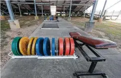  ?? Photos by Jason Fochtman / Staff photograph­er ?? Custodian Phillip Ramirez, top, helps clean and sanitize the weight room at Magnolia High. As schools open strength and conditioni­ng Monday, all stations must comply with distance guidelines, bottom.