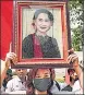  ?? AFP ?? A protester holds an image of Aung San Suu Kyi during a demonstrat­ion outside the UN office in Bangkok.