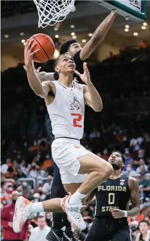  ?? AL DIAZ adiaz@miamiheral­d.com ?? Hurricanes guard Isaiah Wong goes up for a layup during the game against the Seminoles at the sold-out Watsco Center on Saturday. Wong scored a team-high 22 points, 18 in the second half.
