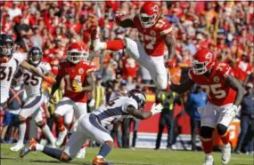  ?? CHARLIE RIEDEL — THE ASSOCIATED PRESS ?? Kareem Hunt hurdles Broncos safety Will Parks on his way to a touchdown during the second half on Oct. 28.