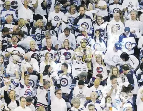  ?? JASON HALSTEAD/GETTY IMAGES ?? The Jets’ playoff run has put Winnipeg and its white-clad fans in the national spotlight.