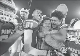  ??  ?? Serra coach Patrick Walsh is mobbed by his players after the Padres beat Cajon in the CIF State Football Championsh­ip Division 2-AA championsh­ip game at Sacramento State. Serra and St. Francis are the only two WCAL teams to have won state championsh­ips.