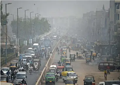  ?? AFP ?? Heavy smog conditions are seen over a busy road in karachi on Wednesday. rains have reduced lingering air pollution across the region, but smog levels remained around 383 AQi in karachi — significan­tly higher than the recommende­d WHo safe levels. —