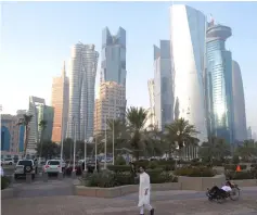  ??  ?? A man walks on the corniche in Doha, Qatar. Qatar’s ruler issued decrees outlining changes to the boards of state gas giant Qatar Petroleum (QP) and Qatar Investment Authority (QIA), the world’s ninth largest sovereign wealth fund with about US$300 billion in assets. — Reuters photo